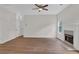 Bright living room with hardwood floors, a fireplace, and a ceiling fan for added comfort at 5891 Buckner Creek Dr, Mableton, GA 30126