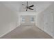 A spacious main bedroom features a ceiling fan and windows providing natural light at 5891 Buckner Creek Dr, Mableton, GA 30126