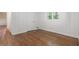 A bedroom with hardwood floors, white walls and woodwork, and a window view at 804 Brookdale Sw Dr, Atlanta, GA 30315