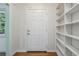 Bright entryway featuring white wood paneling, hardwood floors, and custom built-in shelving at 804 Brookdale Sw Dr, Atlanta, GA 30315