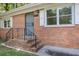Inviting front entrance with decorative wrought iron security door and classic brick stairs at 804 Brookdale Sw Dr, Atlanta, GA 30315