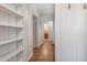 Hallway with hardwood floors, built-in shelving, and fresh white paint at 804 Brookdale Sw Dr, Atlanta, GA 30315