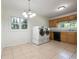 Bright laundry room with tile flooring, a window, and updated appliances at 804 Brookdale Sw Dr, Atlanta, GA 30315