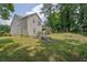 Back exterior view featuring a deck with stairs and a large backyard at 1010 San Marcos Cv, Lawrenceville, GA 30043