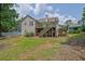 Back exterior view featuring a deck with stairs and a large backyard at 1010 San Marcos Cv, Lawrenceville, GA 30043