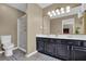 Bathroom features a double sink vanity with black cabinets and a glass enclosed shower at 1010 San Marcos Cv, Lawrenceville, GA 30043