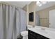 Bathroom featuring a shower and sink with dark cabinets at 1010 San Marcos Cv, Lawrenceville, GA 30043