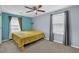 Bedroom with neutral carpet, ceiling fan, and two bright windows at 1010 San Marcos Cv, Lawrenceville, GA 30043