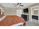 Inviting bedroom with a large dresser with tv, natural light, and ensuite bath access at 1010 San Marcos Cv, Lawrenceville, GA 30043