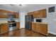 Spacious kitchen with stainless steel appliances, oak cabinets, and modern lighting at 1010 San Marcos Cv, Lawrenceville, GA 30043