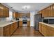 Bright kitchen featuring modern appliances, oak cabinetry, and a convenient layout at 1010 San Marcos Cv, Lawrenceville, GA 30043