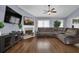 Spacious living room featuring a fireplace, large sectional sofa, and ample natural light at 1010 San Marcos Cv, Lawrenceville, GA 30043