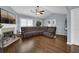 Open living room featuring hardwood floors, fireplace, and a spacious sectional sofa at 1010 San Marcos Cv, Lawrenceville, GA 30043