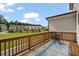 A back porch with a seating area overlooking a green space and the backs of other homes at 114 Brackley Dr, Cumming, GA 30040
