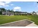 A well maintained lawn provides an open view of townhomes and mature trees at 114 Brackley Dr, Cumming, GA 30040