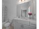 Bright bathroom featuring a large mirror, vanity, and bathtub with shower curtain at 114 Brackley Dr, Cumming, GA 30040