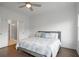 A primary bedroom with hardwood floors, a ceiling fan, and an attached bath with a glass shower at 114 Brackley Dr, Cumming, GA 30040