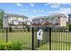 View of neighborhood dog park and modern townhomes in a landscaped community at 114 Brackley Dr, Cumming, GA 30040