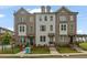 Charming townhome exteriors feature a mix of brick and painted facades with manicured lawns at 114 Brackley Dr, Cumming, GA 30040