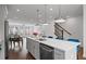 An open concept kitchen featuring a kitchen island, stainless steel appliances, and hardwood flooring at 114 Brackley Dr, Cumming, GA 30040
