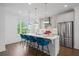 A modern kitchen island with barstool seating, stainless appliances, pendant lighting, and plenty of sunlight at 114 Brackley Dr, Cumming, GA 30040