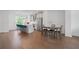 A spacious kitchen with an island featuring bar seating and stainless steel appliances adjacent to a dining space at 114 Brackley Dr, Cumming, GA 30040