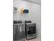 Laundry room featuring modern washer and dryer, as well as a wire rack for storage at 114 Brackley Dr, Cumming, GA 30040