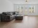 Spacious living room with hardwood floors, large windows and a comfortable sectional sofa at 114 Brackley Dr, Cumming, GA 30040