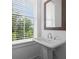 A powder room featuring a pedestal sink and a window with natural light at 114 Brackley Dr, Cumming, GA 30040