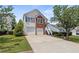 Charming home with a two-car garage, well-maintained lawn, and welcoming front entrance with stairs at 1910 Towne Park Dr, Mcdonough, GA 30252