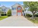 Charming two-story home features a two-car garage, brick accents, and well-manicured landscaping at 1910 Towne Park Dr, Mcdonough, GA 30252