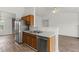Spacious kitchen features stainless steel appliances, wood cabinets, and hardwood flooring at 1910 Towne Park Dr, Mcdonough, GA 30252