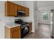 Well-lit kitchen features wood cabinets, stainless steel appliances, and hardwood flooring at 1910 Towne Park Dr, Mcdonough, GA 30252