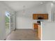 Eat-in kitchen featuring hardwood floors, wood cabinets, and access to the patio via glass sliding doors at 1910 Towne Park Dr, Mcdonough, GA 30252