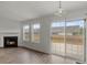 Cozy living room with hardwood floors, a fireplace, and sliding glass doors leading to the outdoor space at 1910 Towne Park Dr, Mcdonough, GA 30252