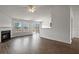 Spacious living room featuring hardwood floors, a cozy fireplace, and large windows for natural light at 1910 Towne Park Dr, Mcdonough, GA 30252