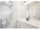 Modern bathroom with white toilet, vanity, tub, and tiled shower at 4508 Meadow Vista Trce, Lithonia, GA 30038