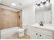 Bright bathroom features tub-shower combo with tile surround and modern vanity at 4508 Meadow Vista Trce, Lithonia, GA 30038