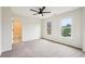 Bedroom featuring a ceiling fan, gray carpet flooring, and two windows at 4508 Meadow Vista Trce, Lithonia, GA 30038