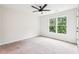 Bedroom with a ceiling fan, carpet flooring, and double windows at 4508 Meadow Vista Trce, Lithonia, GA 30038
