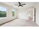 Carpeted bedroom with windows, ceiling fan, and an ensuite bathroom at 4508 Meadow Vista Trce, Lithonia, GA 30038