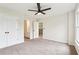 Bright bedroom features carpet flooring, ceiling fan, and a bathroom doorway at 4508 Meadow Vista Trce, Lithonia, GA 30038