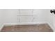 Carpeted closet with white wire shelves, and black door handle at 4508 Meadow Vista Trce, Lithonia, GA 30038