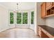 Bright breakfast nook with hardwood floors, built-in cabinets, and large windows overlooking greenery at 4508 Meadow Vista Trce, Lithonia, GA 30038