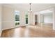 Bright dining room featuring hardwood floors, large windows, and a modern chandelier at 4508 Meadow Vista Trce, Lithonia, GA 30038