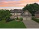 Exterior shot of a two-story brick and siding home featuring a three-car garage at 4508 Meadow Vista Trce, Lithonia, GA 30038
