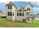Back exterior of a siding home with windows, patio, deck, and green trees at 4508 Meadow Vista Trce, Lithonia, GA 30038