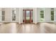 Bright foyer featuring hardwood floors, decorative glass front door, and beautiful trim work at 4508 Meadow Vista Trce, Lithonia, GA 30038