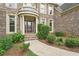 Close up of the brick home featuring a decorative glass front door and landscaped yard at 4508 Meadow Vista Trce, Lithonia, GA 30038