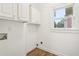 Bright laundry room with white cabinets and vinyl floors at 4508 Meadow Vista Trce, Lithonia, GA 30038